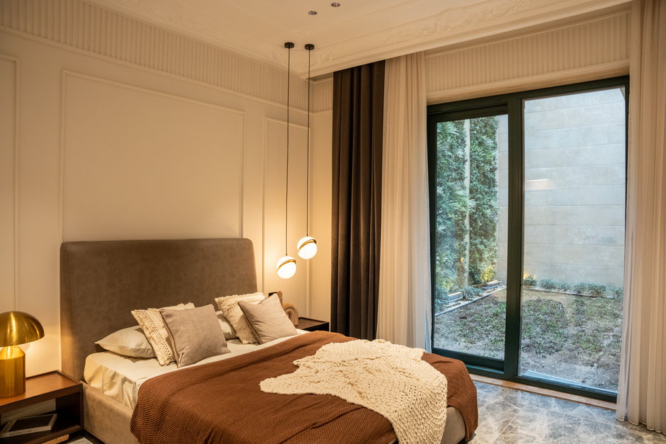 Bedroom with sliding glass doors and light curtains