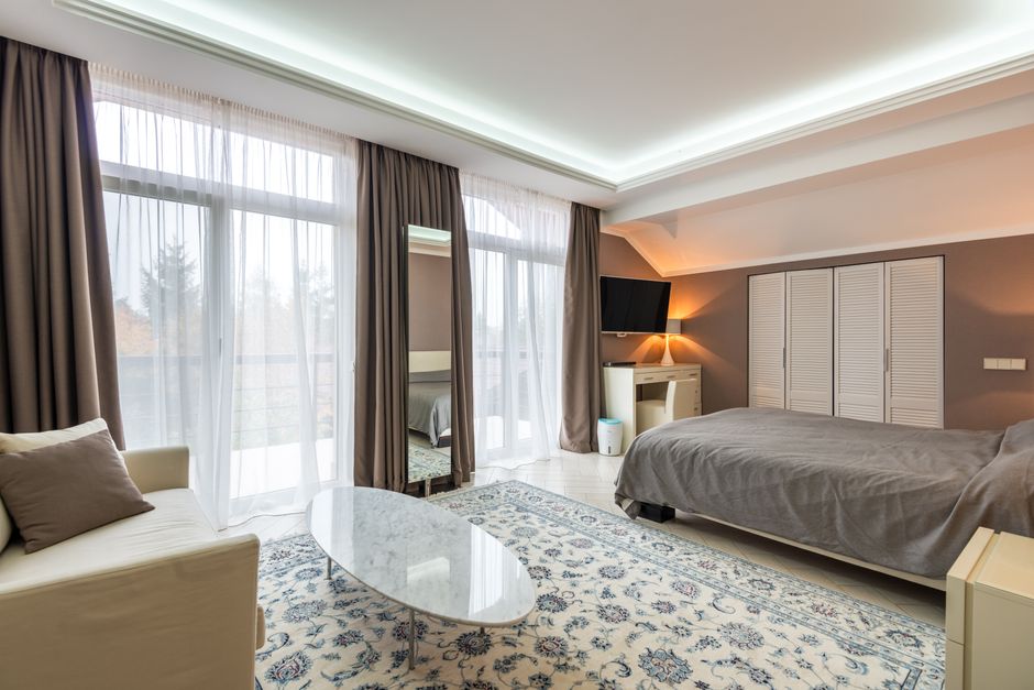 Calm bedroom with large windows and white curtains