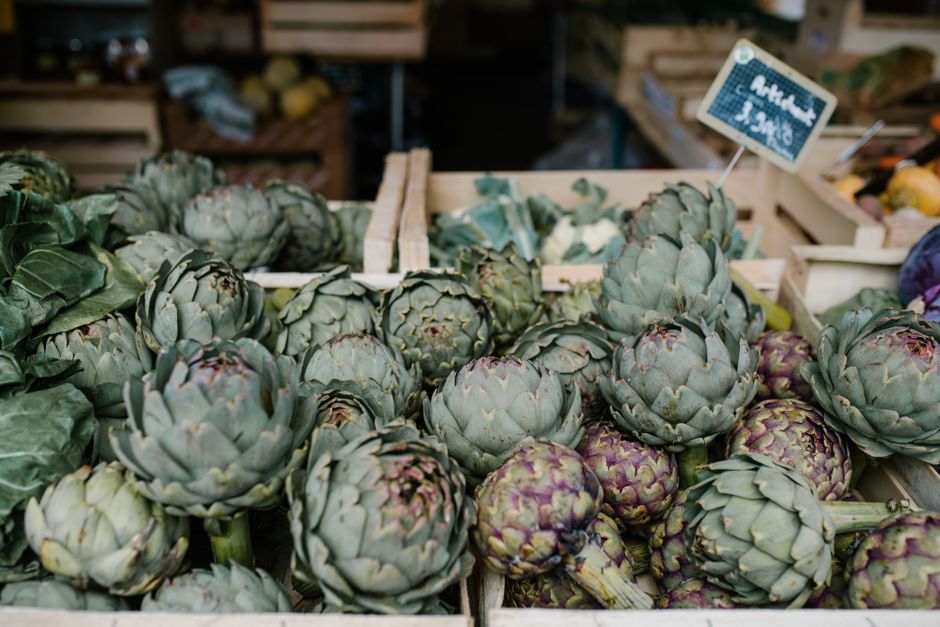 Crates of fresh artichokes at a market