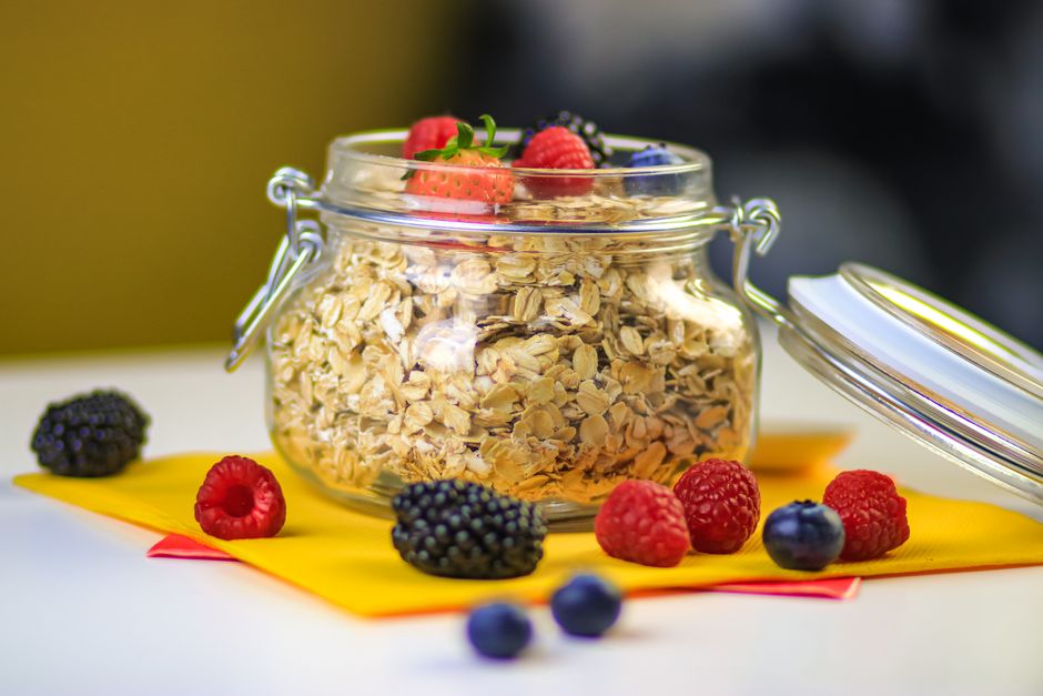 Glass jar of oats topped with fresh berries