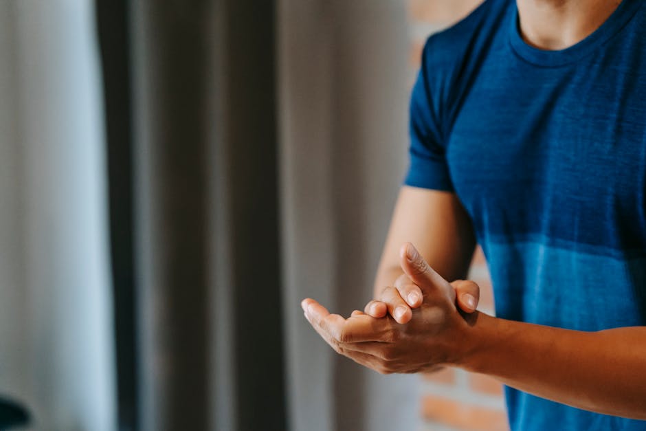 Crop unrecognizable male in t shirt clapping hands for encourage and support in sports club