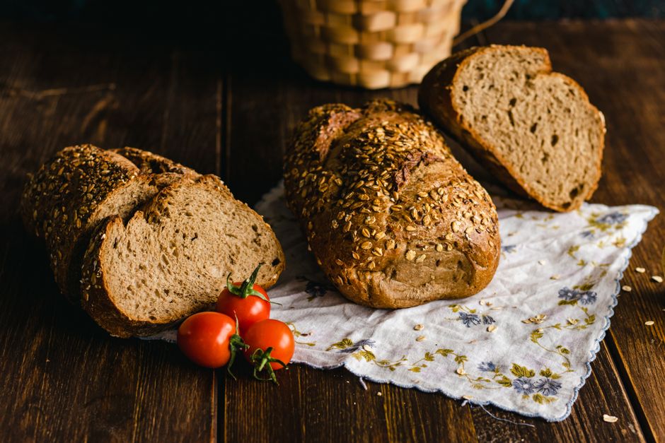 Loaves of whole grain bread on a wooden board
