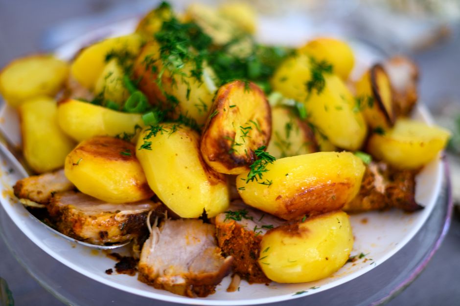 Plate of roasted potatoes and meat served for a holiday meal