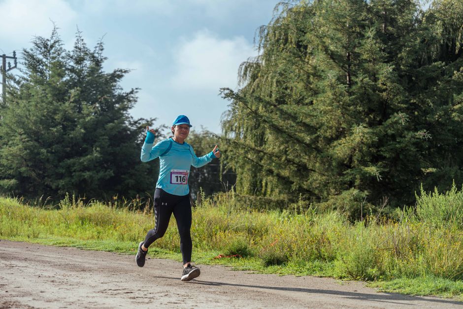Runner jogging along a grassy path in summer