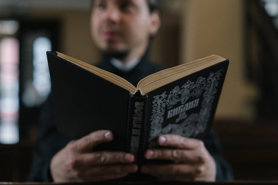 A man reads a Bible inside a church setting, highlighting faith and spirituality.