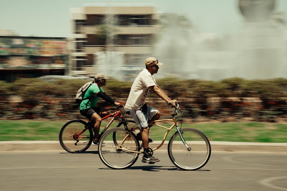Two people cycling on a quiet countryside road